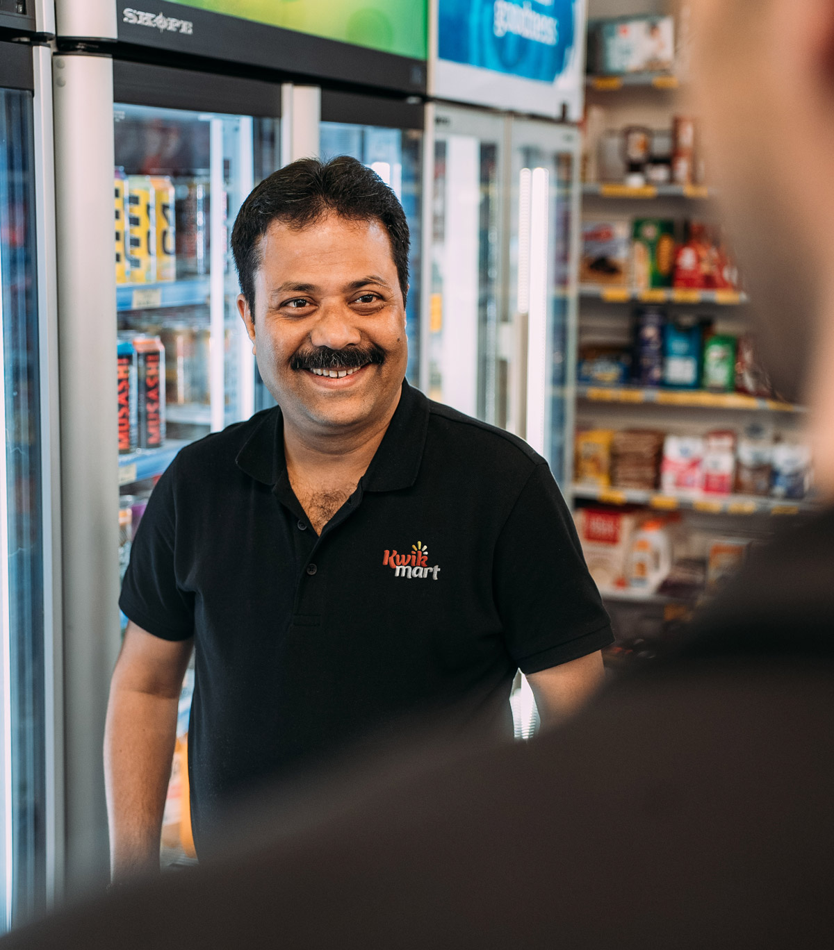 Kiwkmart - Partho Das in store in a Kwikmart Tee